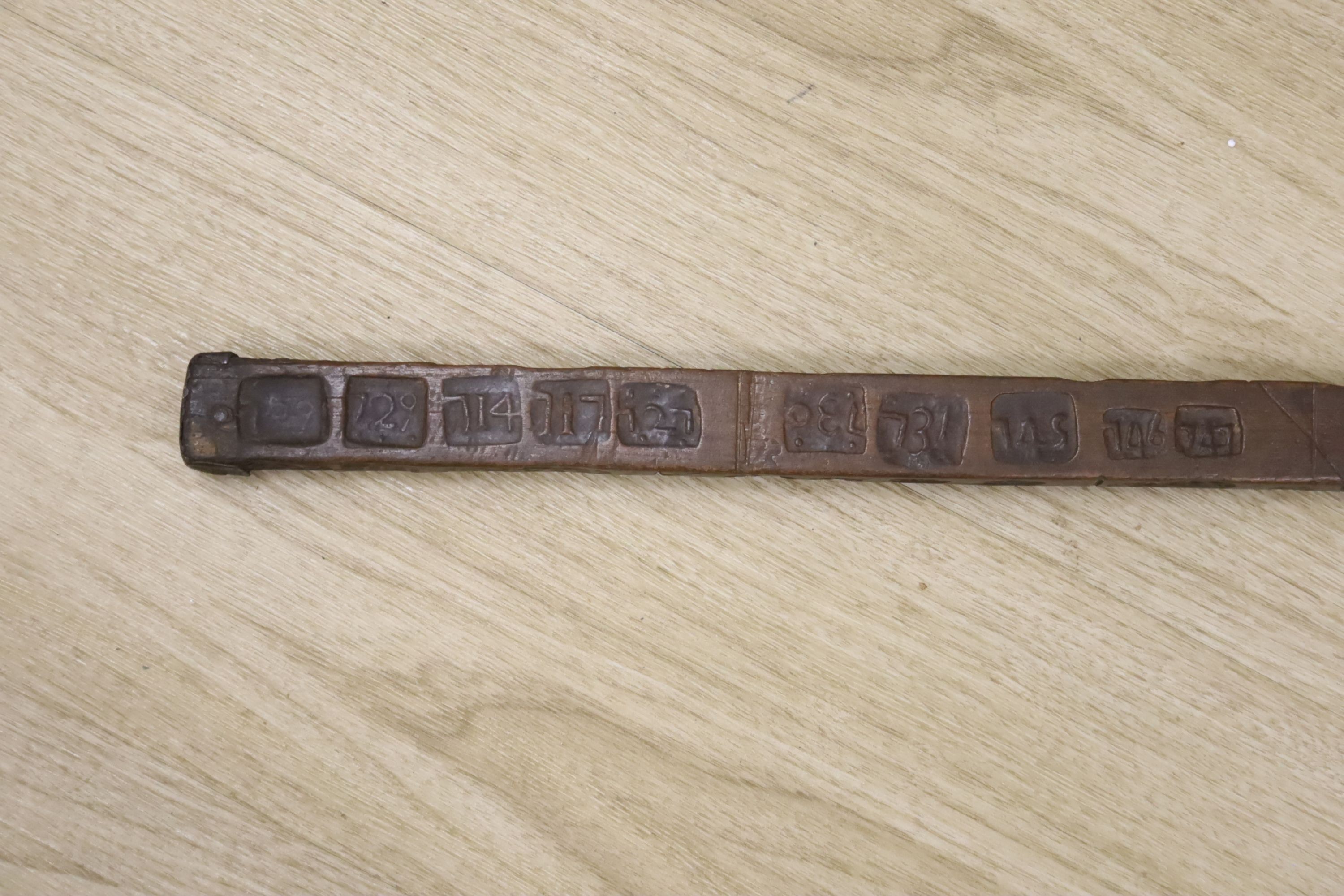 An unusual 18th/19th century rule/gauge or tally stick with impressed numerals, 26cm long